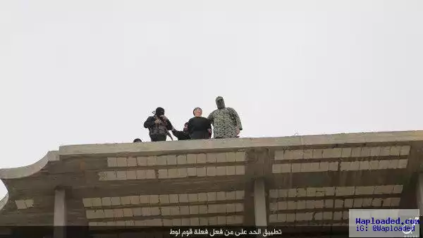 Photos: Children watch as ISIS throw man off a high-rise building in Syria and stone him to death for being gay